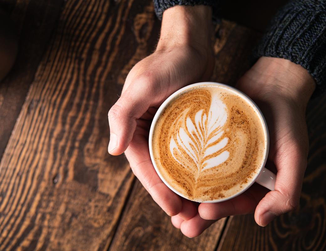Close up of hands holding a cup of coffee 