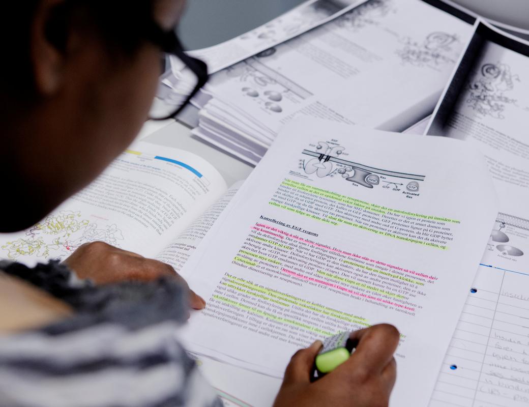 Close up of students hand writing